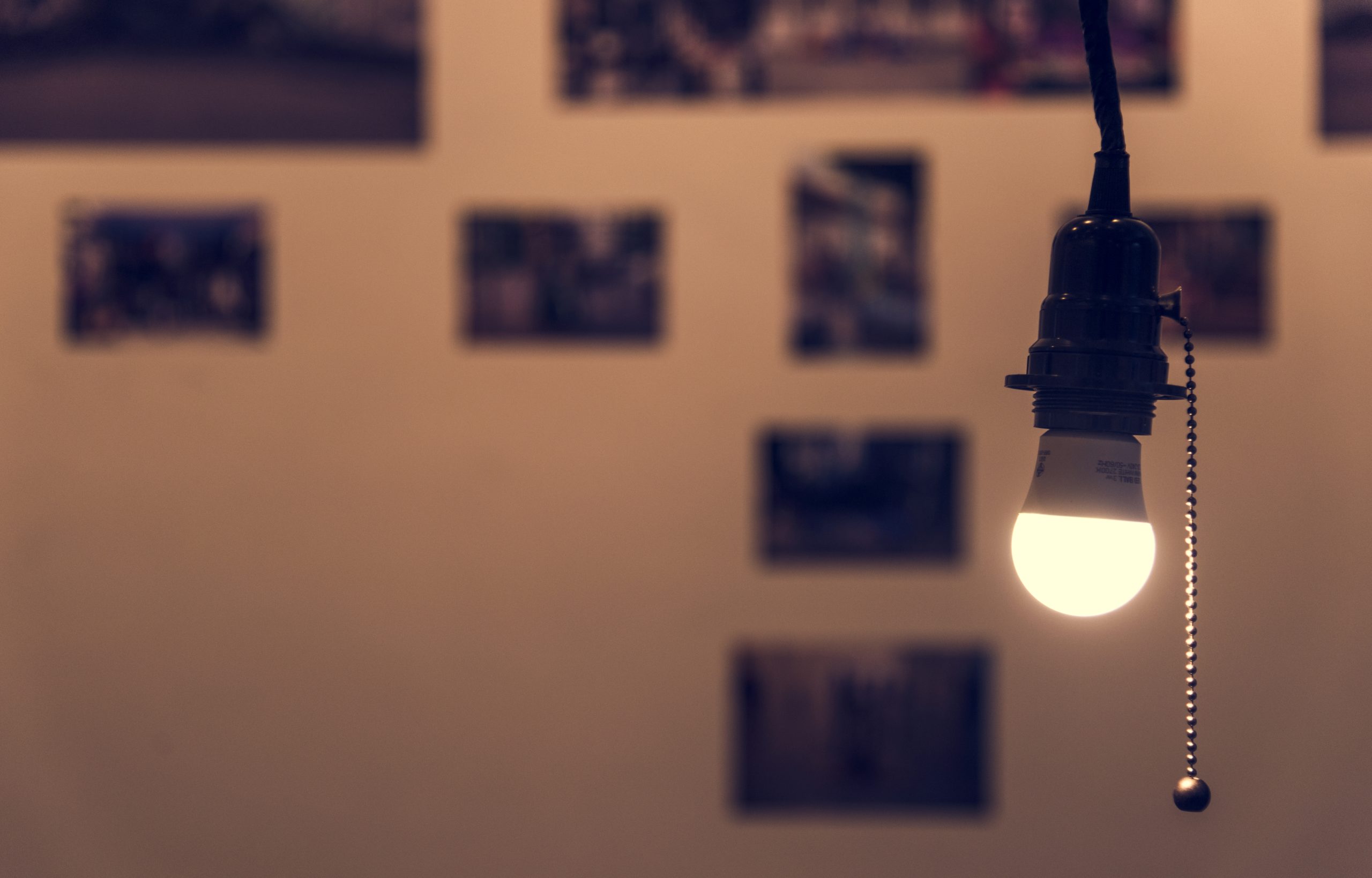 A bright light bulb hanging in a room